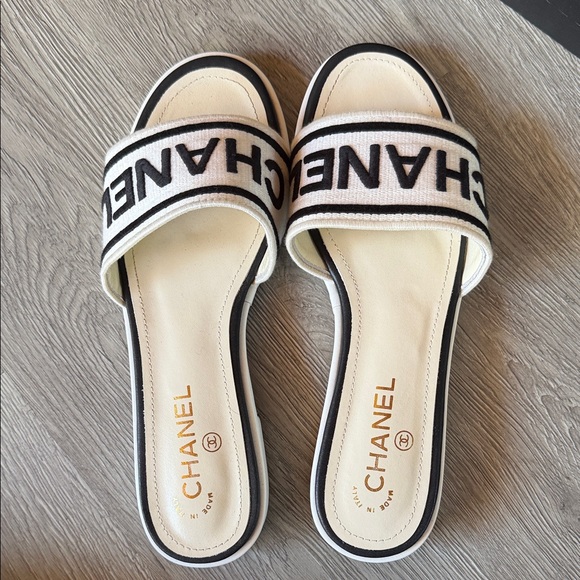 CHANEL Shoes - CHANEL Cream and Black Logo Slide Sandals